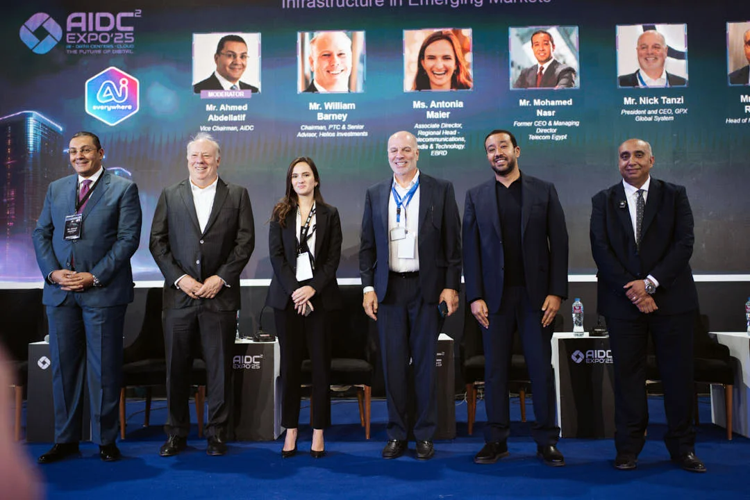 Speakers line up on stage after an AIDC² Expo 2025 panel